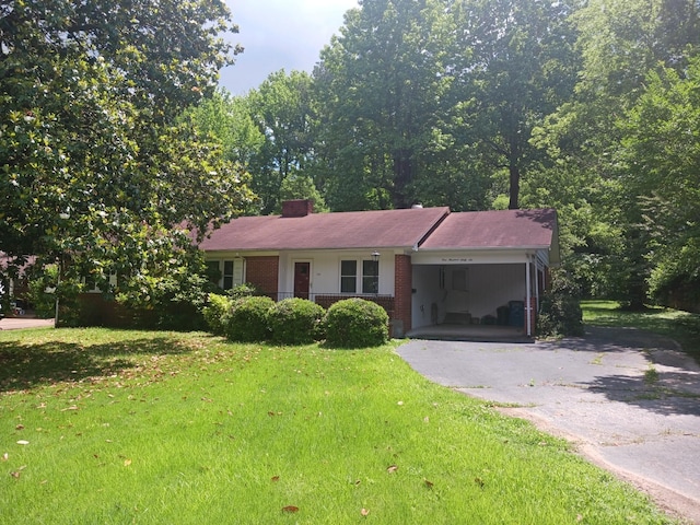 166 Westview St, Camden, TN 38320 - ranch-style house with asphalt driveway, a carport, a front lawn, and brick siding