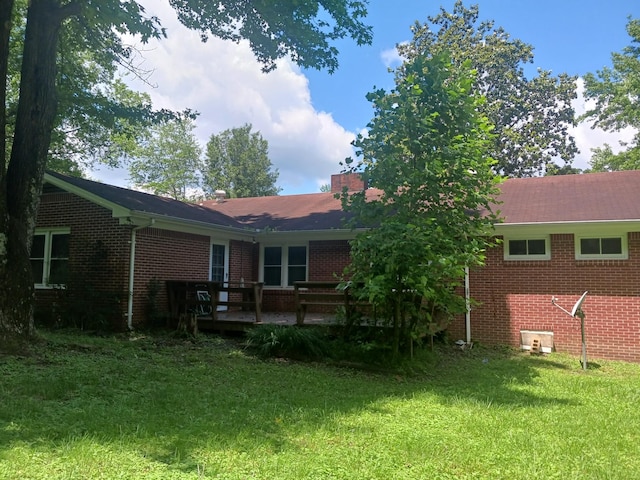 166 Westview St, Camden, TN 38320 - back of property featuring brick siding, a yard, and a deck