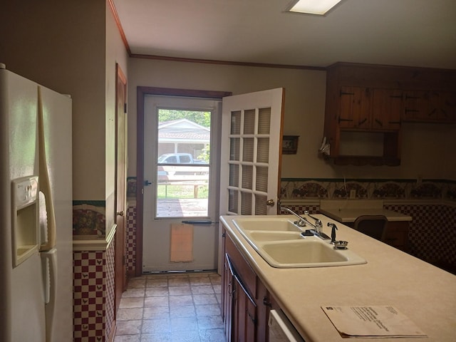 166 Westview St, Camden, TN 38320 - kitchen featuring white fridge with ice dispenser, a sink, light countertops, crown molding, and dishwasher