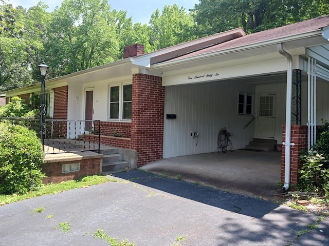 166 Westview St, Camden, TN 38320 - ranch-style home with entry steps, brick siding, driveway, and a chimney