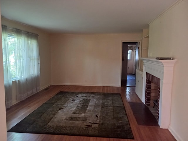 166 Westview St, Camden, TN 38320 - unfurnished living room with a fireplace with flush hearth, wood finished floors, and baseboards