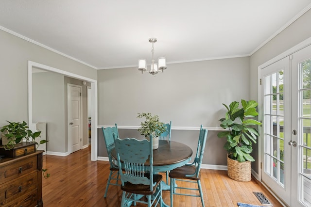 307 S Hummingbird Ln, Dickson, TN 37055 - dining area featuring wood-type flooring, a chandelier, baseboards, and ornamental molding