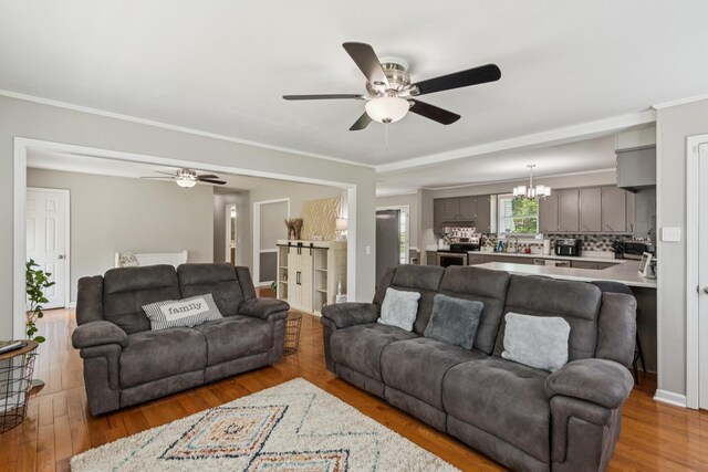 307 S Hummingbird Ln, Dickson, TN 37055 - living area with ceiling fan, wood finished floors, and a chandelier