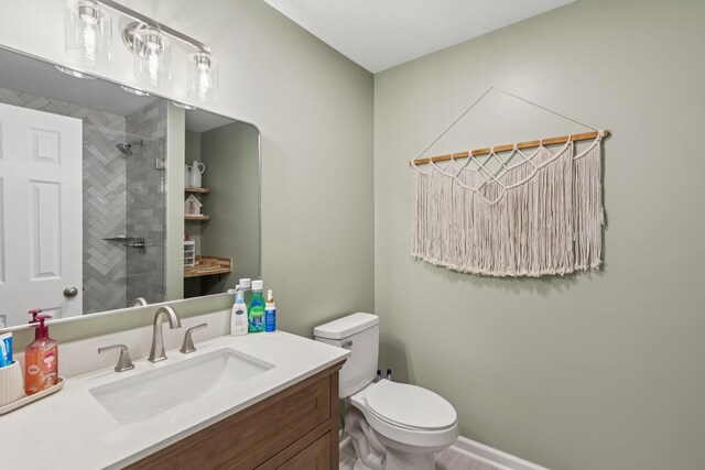 307 S Hummingbird Ln, Dickson, TN 37055 - bathroom featuring vanity, toilet, and tiled shower