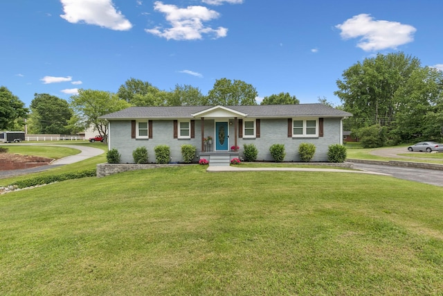 307 S Hummingbird Ln, Dickson, TN 37055 - single story home featuring a front yard, asphalt driveway, and brick siding