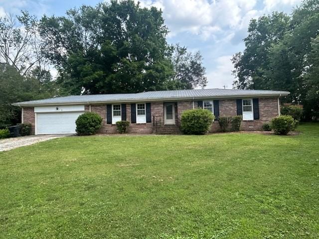 203 Arnold Ave, Tullahoma, TN 37388 - ranch-style house featuring gravel driveway, brick siding, an attached garage, and a front yard