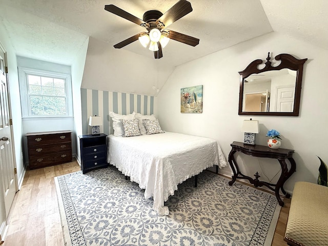 512 Riverview Dr, Franklin, TN 37064 - bedroom with light wood finished floors, vaulted ceiling, wallpapered walls, a textured ceiling, and ceiling fan