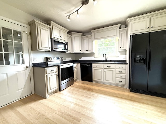 512 Riverview Dr, Franklin, TN 37064 - kitchen featuring black appliances, dark countertops, light wood-type flooring, and a sink