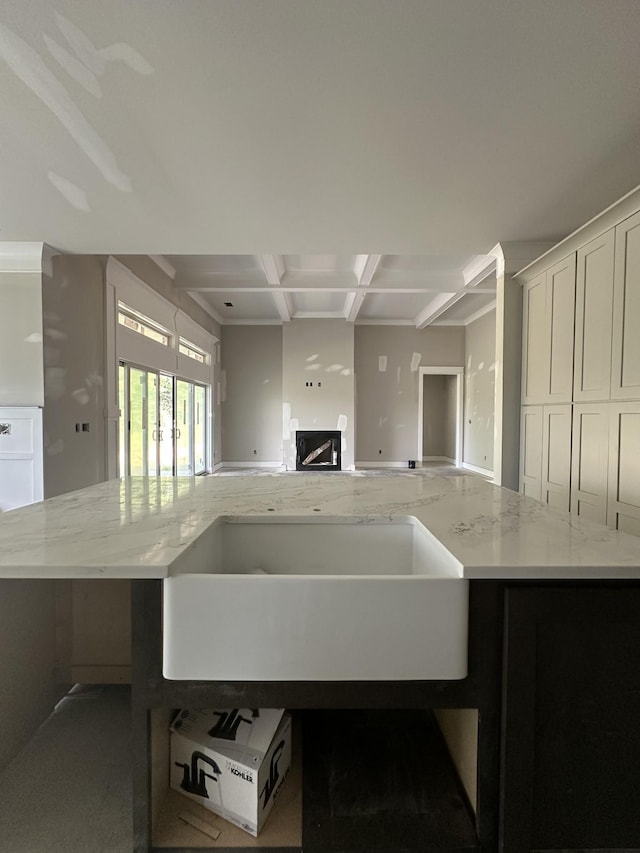 887 Ovoca Lake Rd, Tullahoma, TN 37388 - kitchen with coffered ceiling, open floor plan, light stone counters, beamed ceiling, and a fireplace