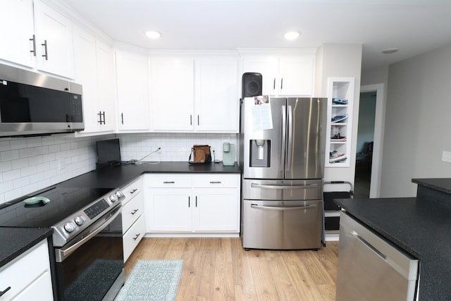 214 Miller Rd, Lafayette, TN 37083 - kitchen featuring stainless steel appliances, dark countertops, white cabinets, light wood-style floors, and recessed lighting