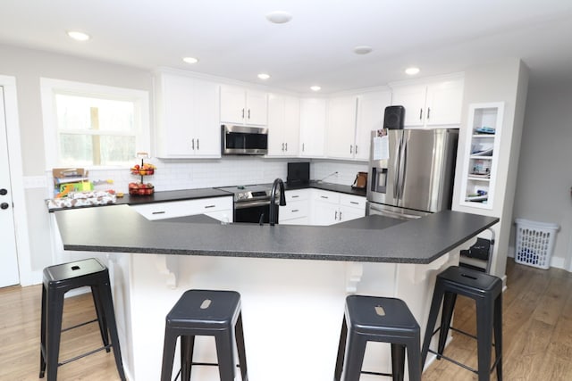 214 Miller Rd, Lafayette, TN 37083 - kitchen with stainless steel appliances, dark countertops, and tasteful backsplash