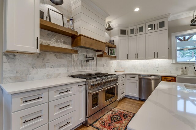 103 Maple St, Smyrna, TN 37167 - kitchen featuring stainless steel appliances, open shelves, light wood finished floors, white cabinetry, and ornamental molding