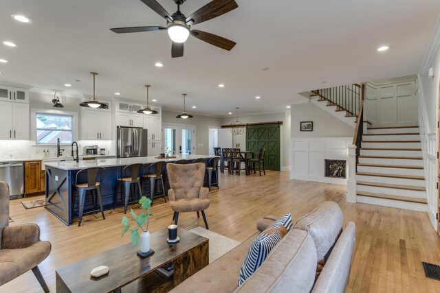 103 Maple St, Smyrna, TN 37167 - living area with stairway, recessed lighting, light wood-style floors, ceiling fan, and ornamental molding