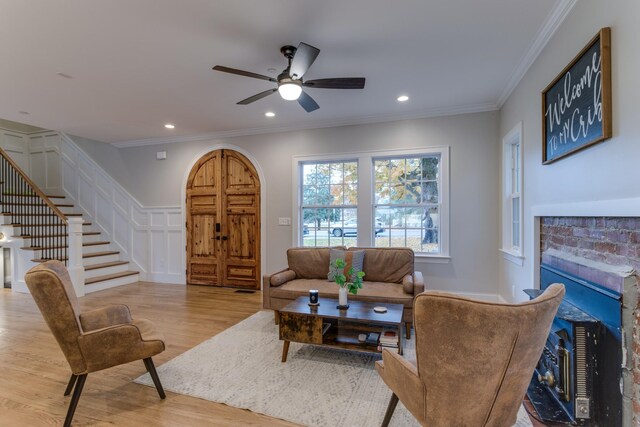 103 Maple St, Smyrna, TN 37167 - living area featuring stairs, wood finished floors, a fireplace, a ceiling fan, and ornamental molding