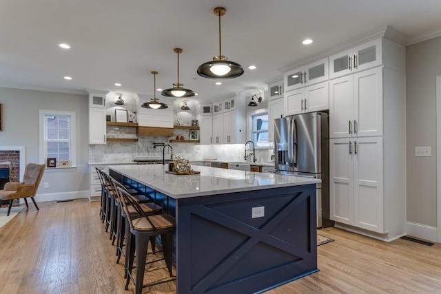 103 Maple St, Smyrna, TN 37167 - kitchen with stainless steel fridge, open shelves, crown molding, white cabinetry, and baseboards