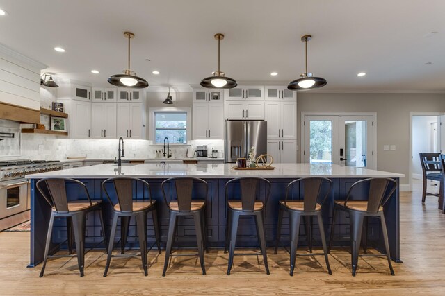 103 Maple St, Smyrna, TN 37167 - kitchen featuring appliances with stainless steel finishes, crown molding, a sink, a large island, and decorative backsplash