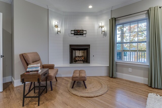 103 Maple St, Smyrna, TN 37167 - sitting room with ornamental molding, wood finished floors, baseboards, a large fireplace, and recessed lighting