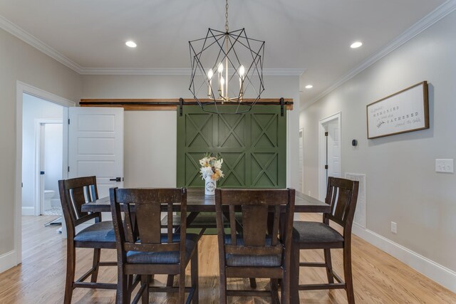 103 Maple St, Smyrna, TN 37167 - dining space featuring a barn door, light wood-type flooring, baseboards, crown molding, and a chandelier