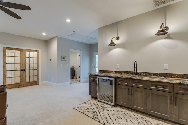 103 Maple St, Smyrna, TN 37167 - kitchen featuring beverage cooler, light carpet, a ceiling fan, a sink, and dark stone countertops