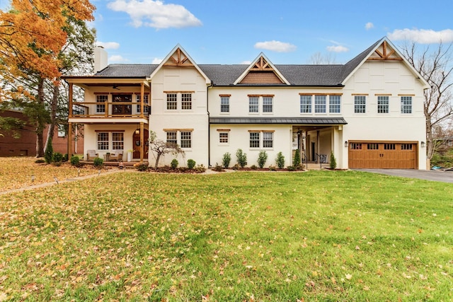 103 Maple St, Smyrna, TN 37167 - view of front of house featuring stucco siding, a balcony, a garage, and a front lawn