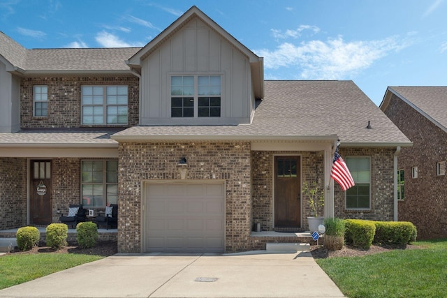 5124 Southfork Blvd, Old Hickory, TN 37138 - view of front of property with a garage, a porch, driveway, board and batten siding, and roof with shingles