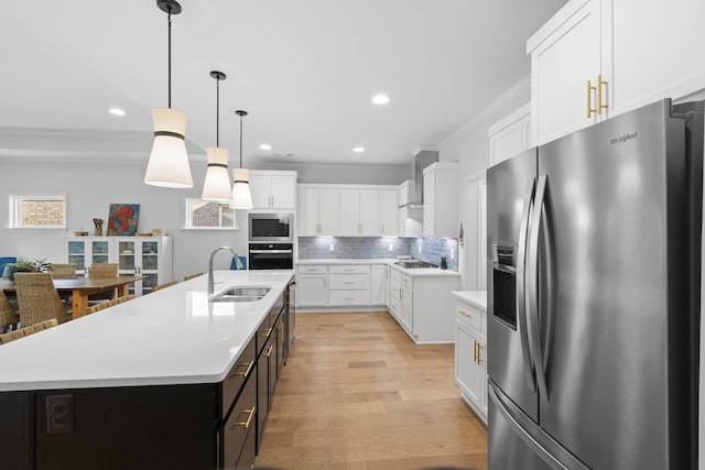 7428 Dodd Retreat Ct, Hermitage, TN 37076 - kitchen featuring stainless steel appliances, a sink, wall chimney range hood, ornamental molding, and white cabinets