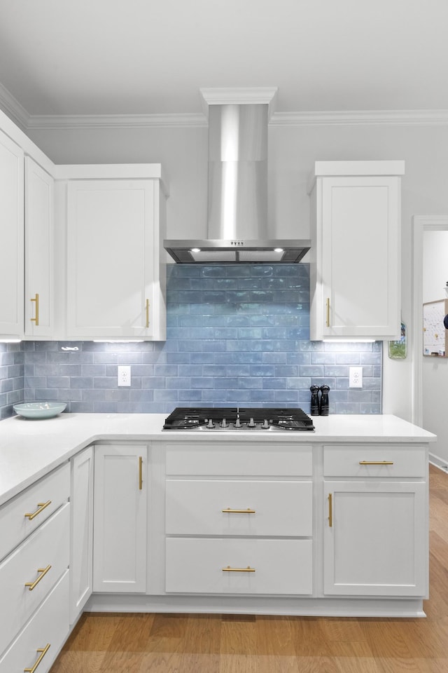 7428 Dodd Retreat Ct, Hermitage, TN 37076 - kitchen featuring wall chimney range hood, stainless steel gas stovetop, ornamental molding, white cabinetry, and light countertops