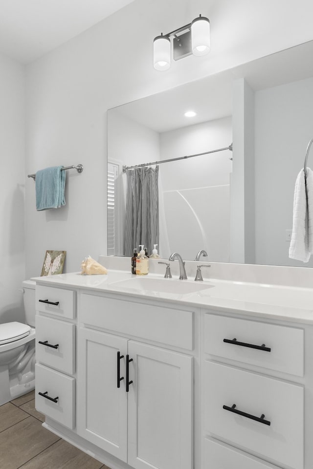 7428 Dodd Retreat Ct, Hermitage, TN 37076 - bathroom featuring toilet, vanity, a shower with curtain, and wood finished floors