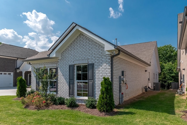 7428 Dodd Retreat Ct, Hermitage, TN 37076 - view of side of home with brick siding, a lawn, central air condition unit, and concrete driveway