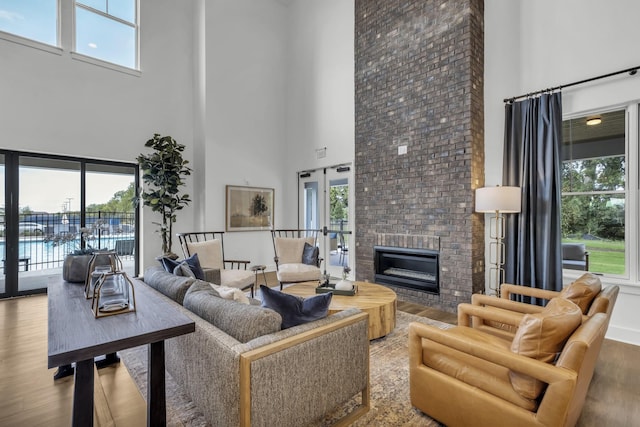 7428 Dodd Retreat Ct, Hermitage, TN 37076 - living area with a high ceiling, wood finished floors, plenty of natural light, and a brick fireplace