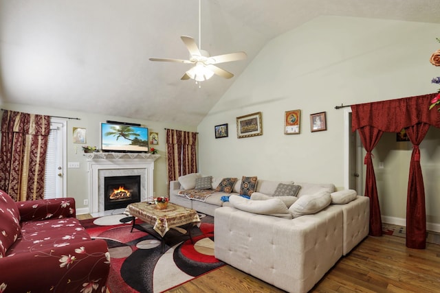 304 Baronswood Dr, Nolensville, TN 37135 - living room with vaulted ceiling, wood finished floors, ceiling fan, a warm lit fireplace, and baseboards