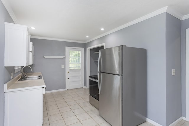 125 Neese Dr, Nashville, TN 37211 - kitchen featuring appliances with stainless steel finishes, white cabinets, light countertops, baseboards, and ornamental molding