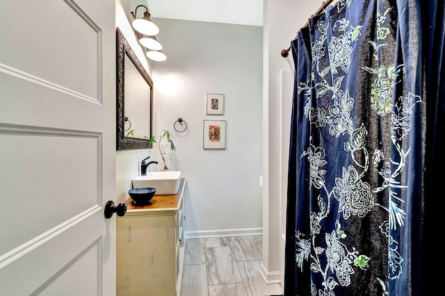 2639 Distillery Rd, Greenbrier, TN 37073 - bathroom with vanity, marble look tiles, baseboards, and a shower with shower curtain