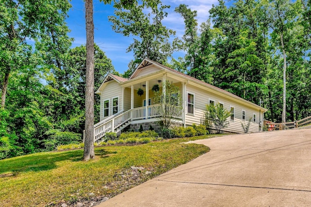 2639 Distillery Rd, Greenbrier, TN 37073 - view of front facade featuring covered porch, a front yard, concrete driveway, and stairway