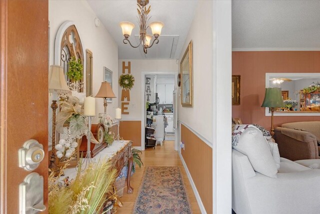 2890 Nance Bend Rd, Clifton, TN 38425 - hall featuring light wood-style flooring and a chandelier