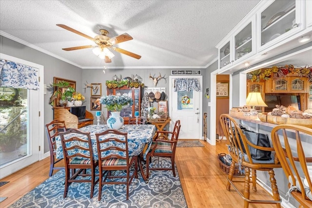 2890 Nance Bend Rd, Clifton, TN 38425 - dining room featuring ceiling fan, light wood-style flooring, crown molding, a textured ceiling, and baseboards