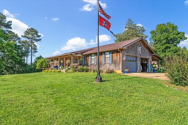 2890 Nance Bend Rd, Clifton, TN 38425 - ranch-style house featuring board and batten siding, a front yard, a detached garage, and metal roof