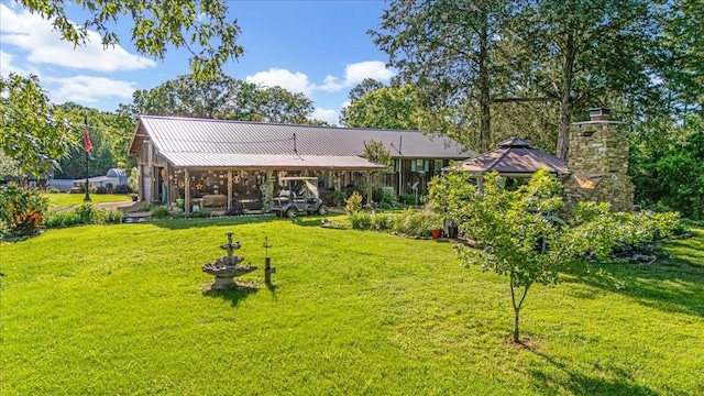 2890 Nance Bend Rd, Clifton, TN 38425 - rear view of house featuring a lawn, metal roof, and a chimney