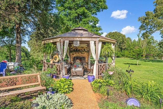 2890 Nance Bend Rd, Clifton, TN 38425 - view of green lawn with a gazebo, an outdoor stone fireplace, and view of wooded area