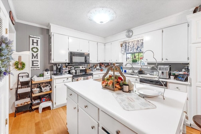 2890 Nance Bend Rd, Clifton, TN 38425 - kitchen featuring black microwave, stainless steel electric range, light countertops, white cabinetry, and a textured ceiling