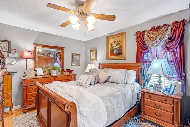 2890 Nance Bend Rd, Clifton, TN 38425 - bedroom featuring light wood finished floors, a textured ceiling, and ceiling fan
