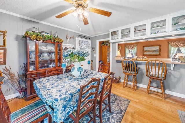 2890 Nance Bend Rd, Clifton, TN 38425 - dining space with light wood-style flooring, crown molding, a ceiling fan, a textured ceiling, and baseboards