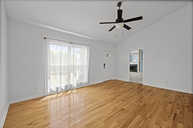 5009 Lanier Dr, Greenbrier, TN 37073 - empty room with ceiling fan, light wood-style floors, lofted ceiling, baseboards, and a fireplace