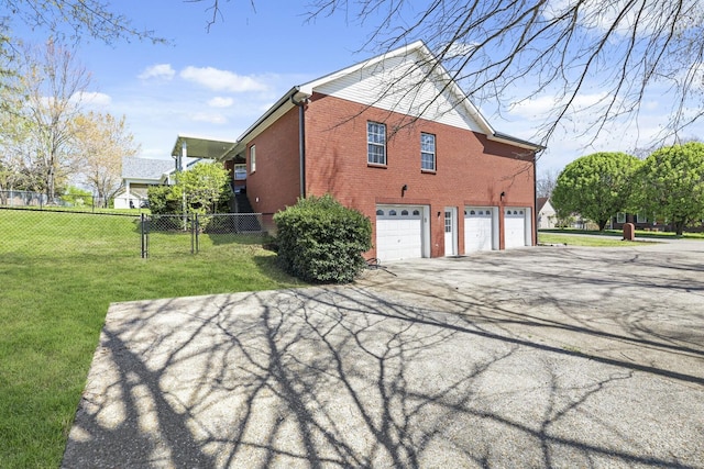 5009 Lanier Dr, Greenbrier, TN 37073 - view of side of home with an attached garage, brick siding, and concrete driveway
