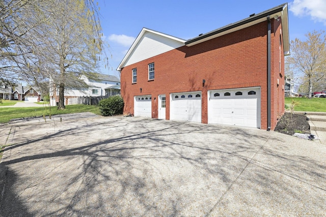 5009 Lanier Dr, Greenbrier, TN 37073 - view of side of home with a garage, brick siding, and concrete driveway