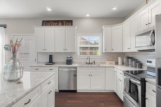 1020 Corey Dr, Lewisburg, TN 37091 - kitchen with stainless steel appliances, a sink, dark wood-style floors, white cabinets, and backsplash