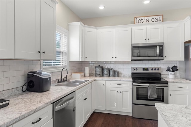 1020 Corey Dr, Lewisburg, TN 37091 - kitchen featuring appliances with stainless steel finishes, a sink, white cabinetry, light countertops, and recessed lighting