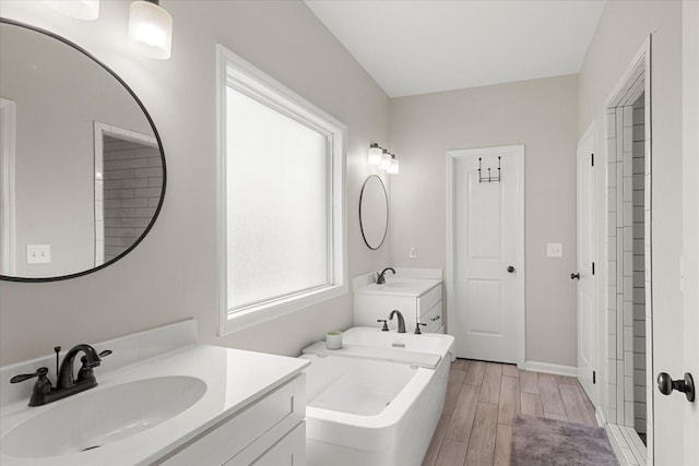 1020 Corey Dr, Lewisburg, TN 37091 - full bathroom featuring a bath, wood tiled floors, two vanities, and baseboards