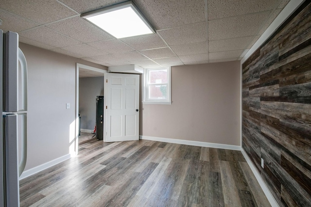 930 Havenhill Dr, Nashville, TN 37217 - unfurnished room with wood finished floors, wood walls, a paneled ceiling, and baseboards