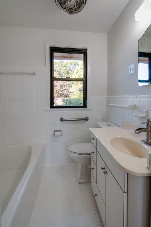 930 Havenhill Dr, Nashville, TN 37217 - full bath with tile walls, toilet, a tub, vanity, and healthy amount of natural light